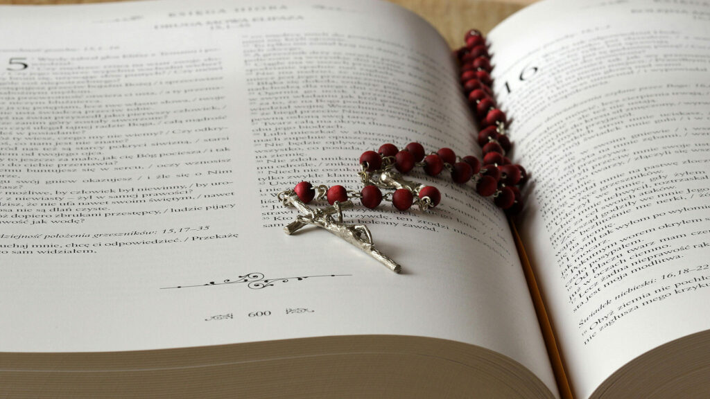 Rosary on Top of Opened Bible